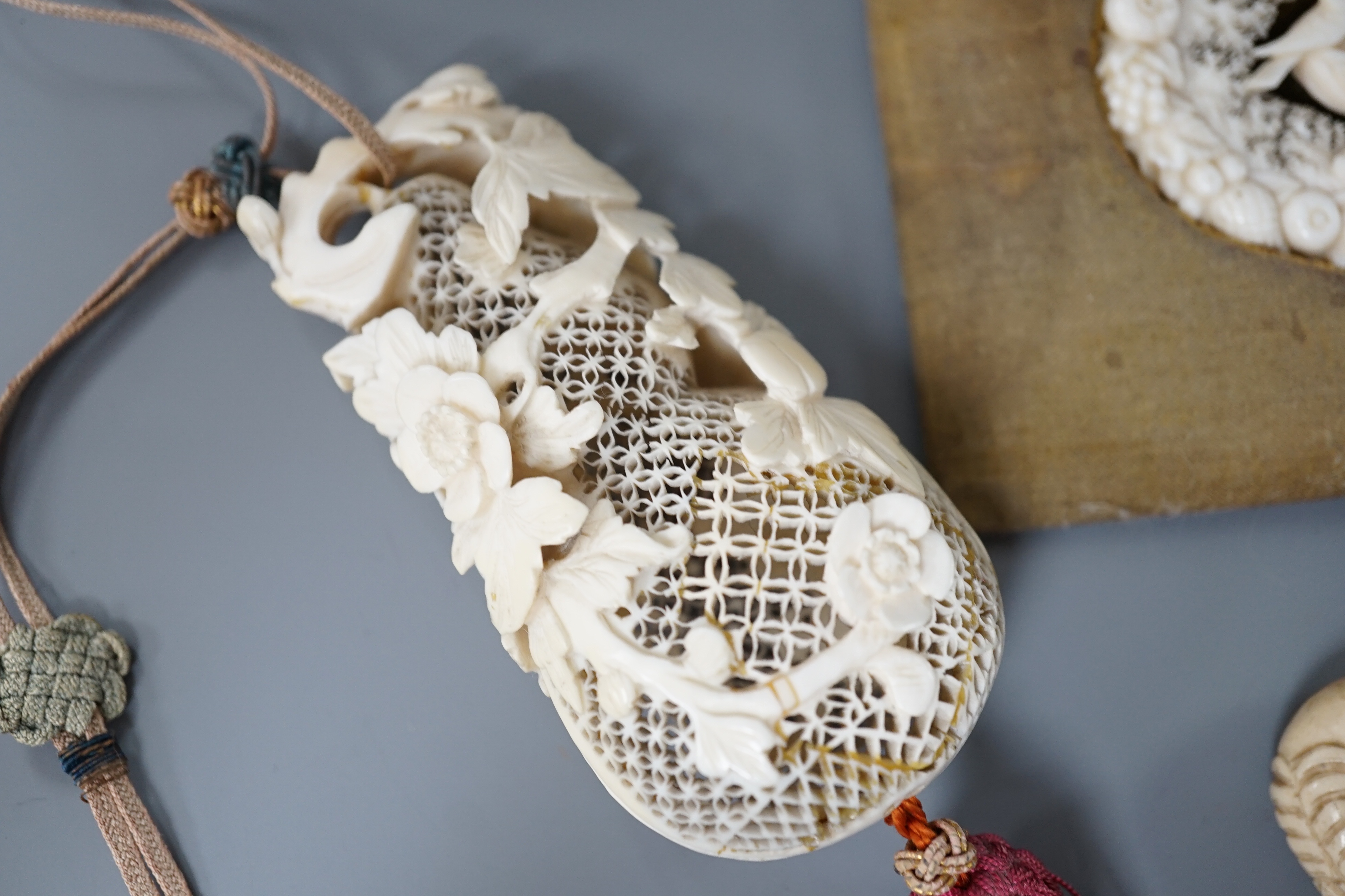 A 19th century Chinese pierced Ivory scent box together with a netsuke modelled as a horse and ivory pierced panel (3)